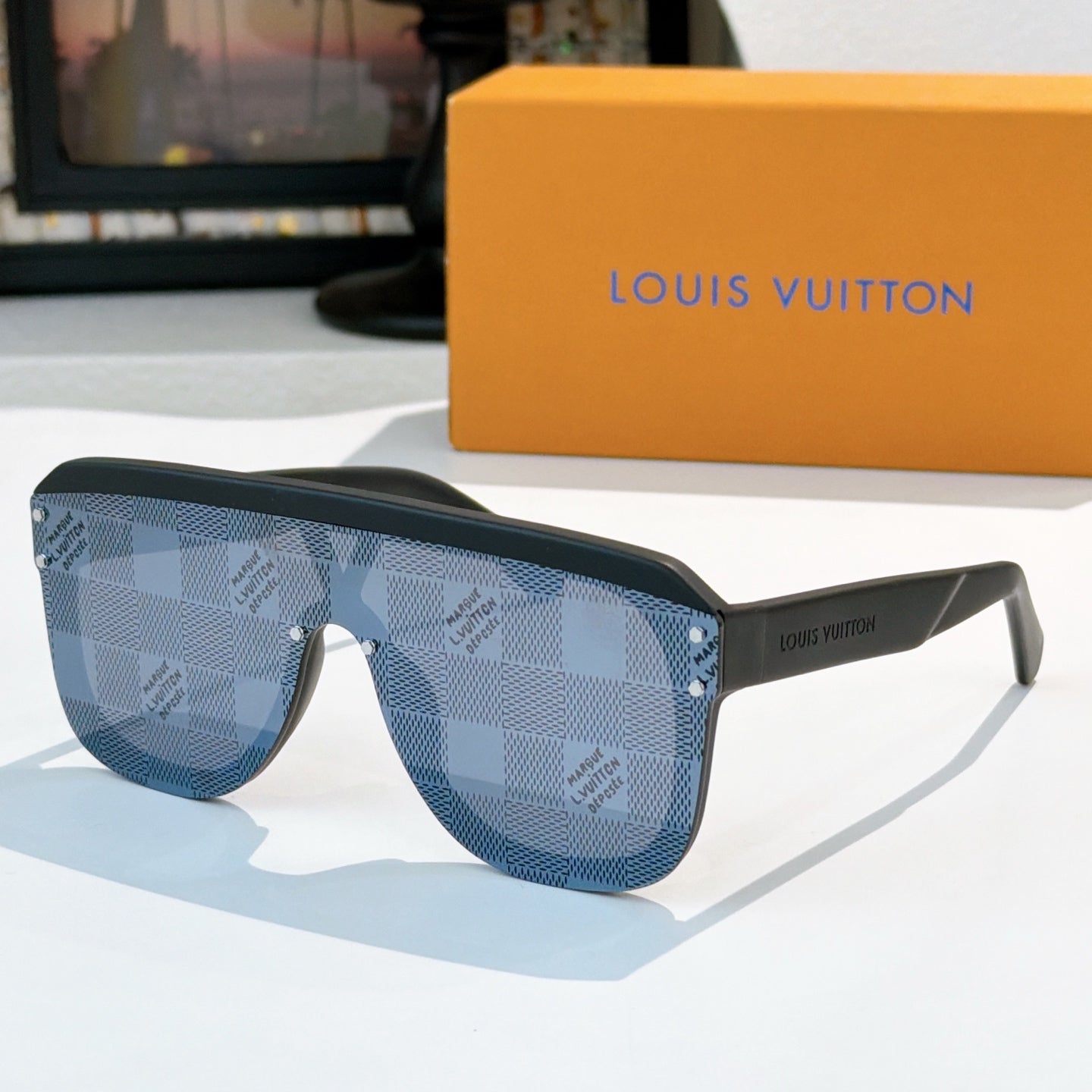 Blue patterned sunglasses with blue lenses and gold-tone rivets