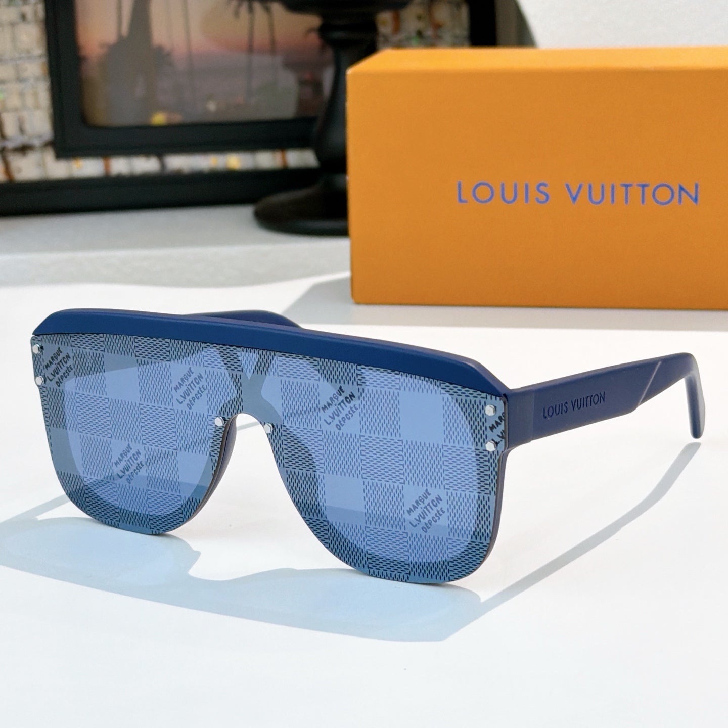 Blue checkered sunglasses with blue lenses and gold-tone rivets