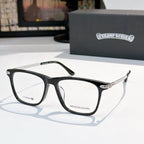 Clear-lens eyeglasses with black frames and metal details.