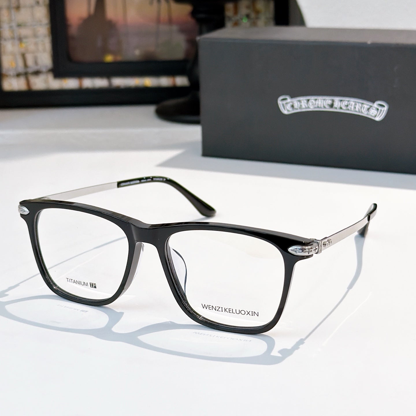 Clear-lens eyeglasses with black frames and metal details.