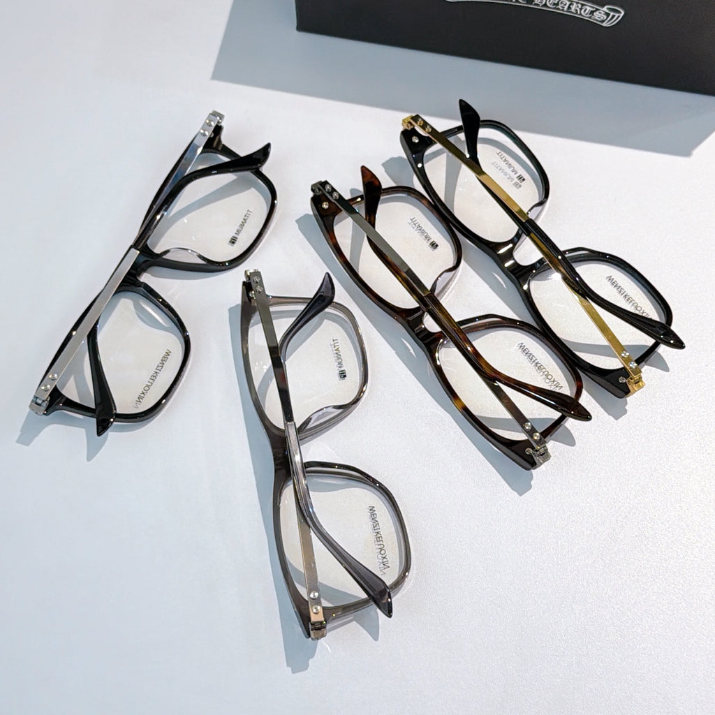 Set of mixed-color eyeglasses with clear lenses on display.