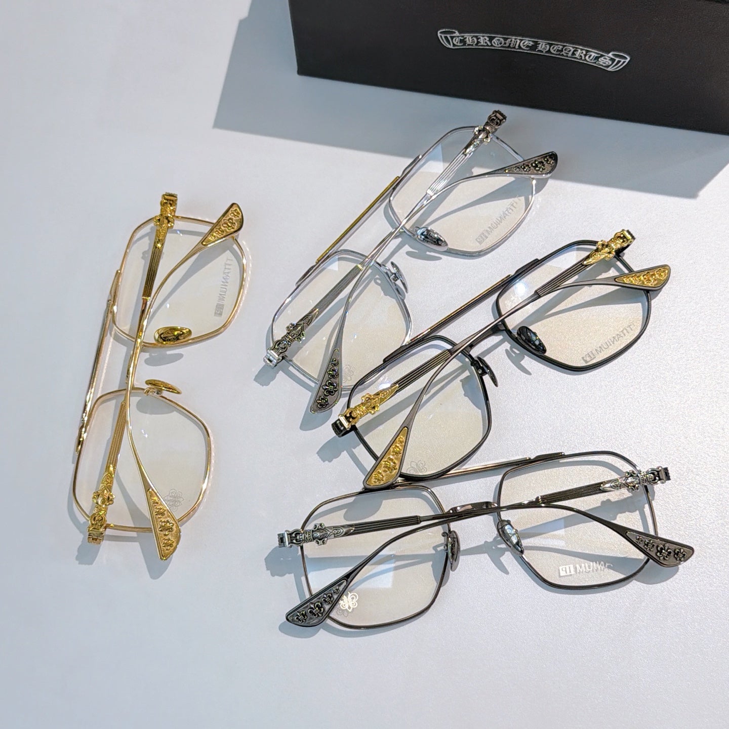 Assorted metal eyeglasses set with clear lenses, gold and silver frames.
