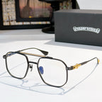 Dark green metal eyeglasses with clear lenses, ornate gold bridge and hinge detail.