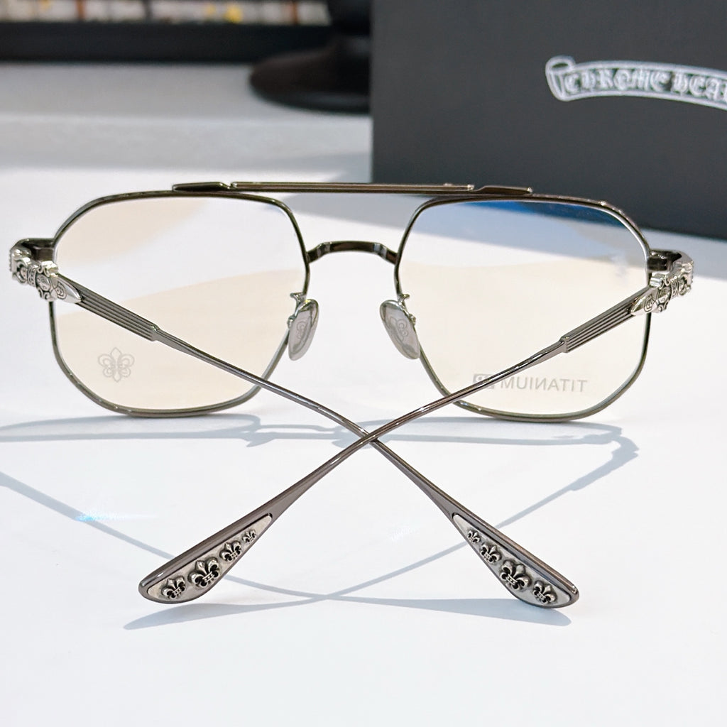 Metal eyeglasses with clear lenses, bronze tone frame and decorative temple arms.