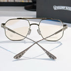 Metal eyeglasses with clear lenses, bronze tone frame and decorative temple arms.