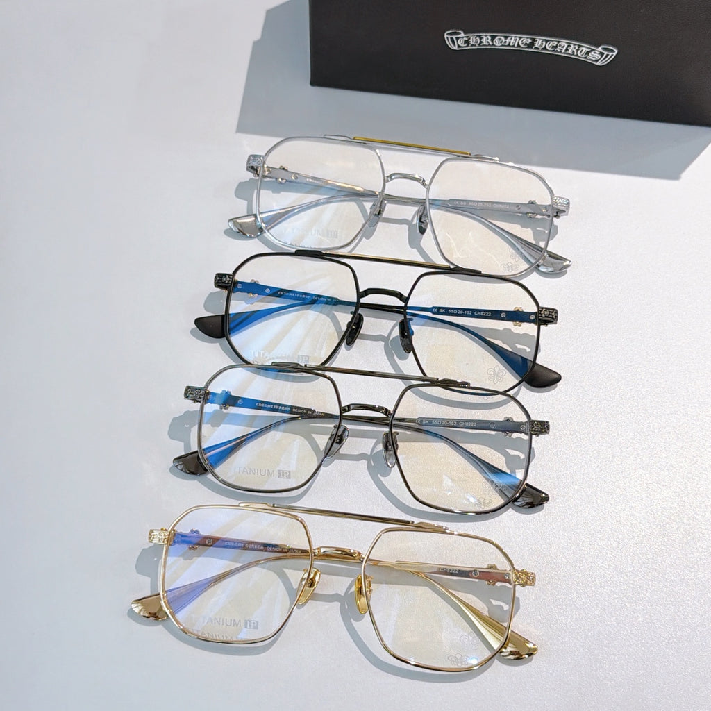 Stacked eyeglasses set with clear lenses in blue, black, and gold frames.