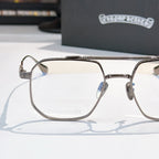 Metal eyeglass frame with clear lenses, embossed temple arms and bridge detail.