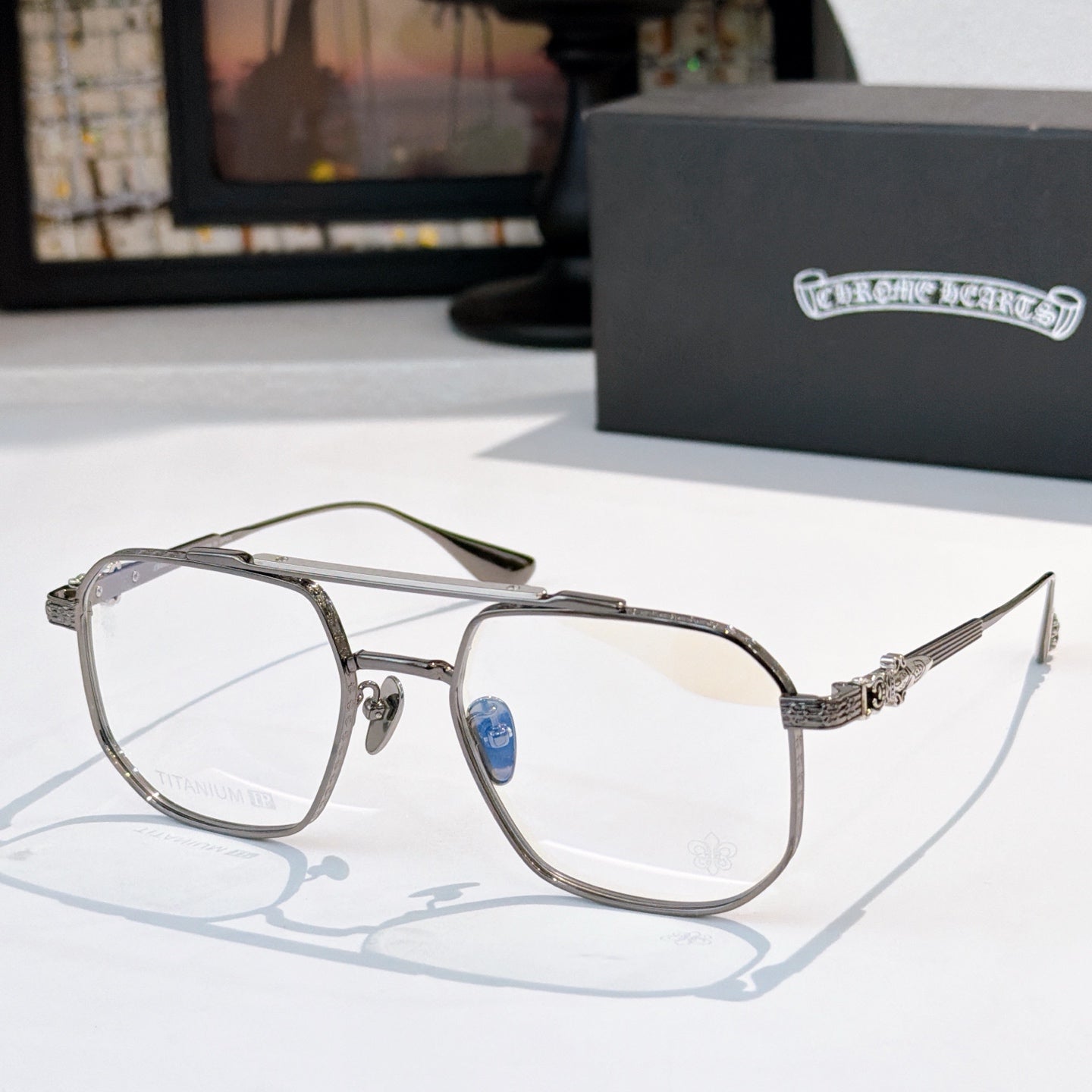 Silver-tone eyeglasses with clear lenses, embellished temple and metal frame.