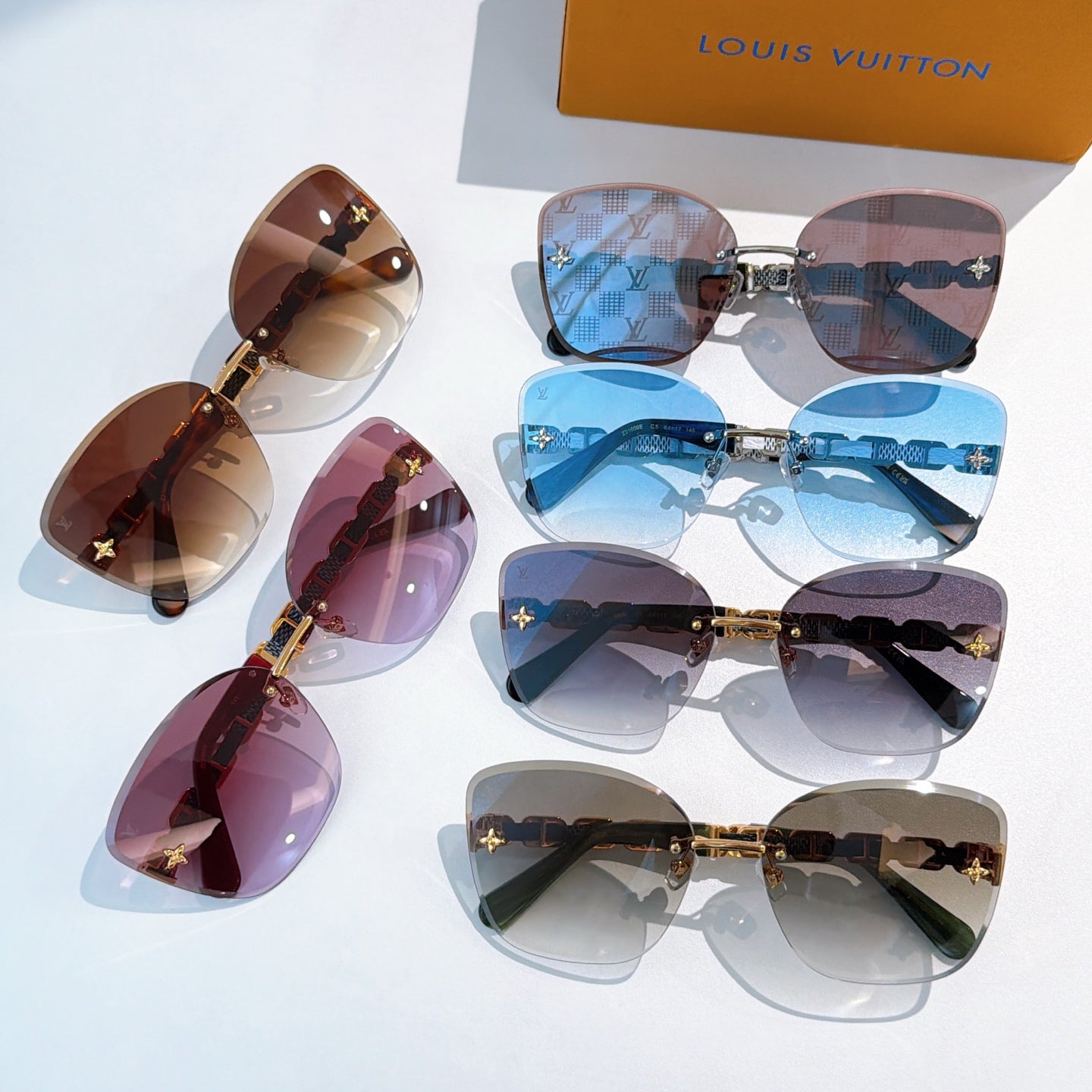 Assorted designer sunglasses with mixed blue, brown, and dark lenses