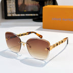 Designer sunglasses with brown gradient lenses and gold link temples