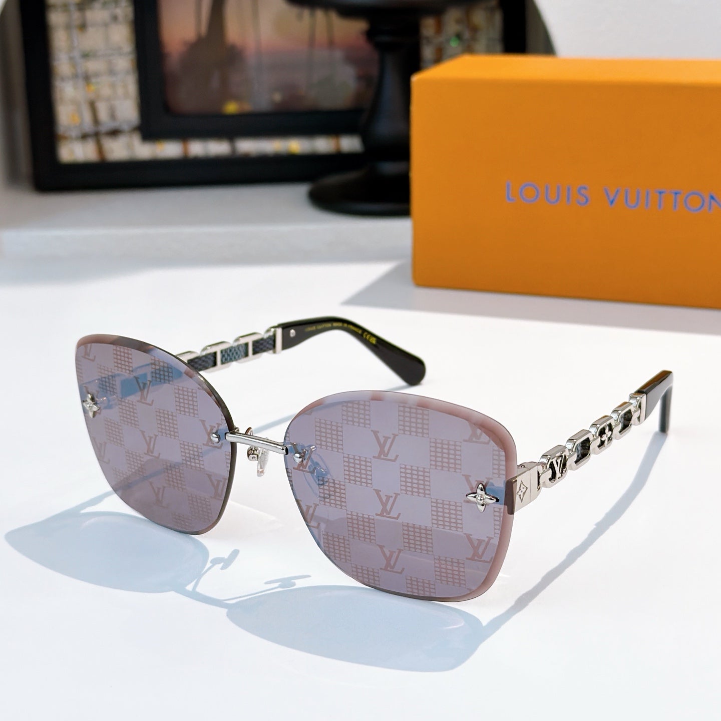 Louis Vuitton sunglasses with pink-brown gradient lenses and gold link temples
