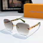 Designer sunglasses with taupe gradient lenses and gold link temples