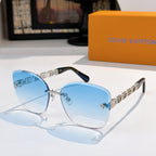Designer sunglasses with light blue gradient lenses and gold link temples