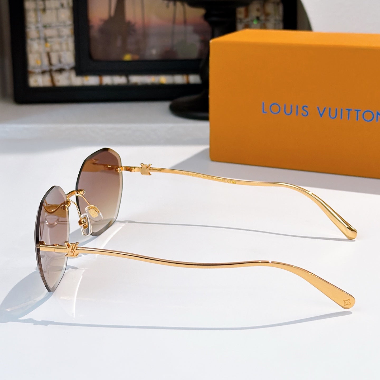 Louis Vuitton gold sunglasses with brown lenses, metal temple detail