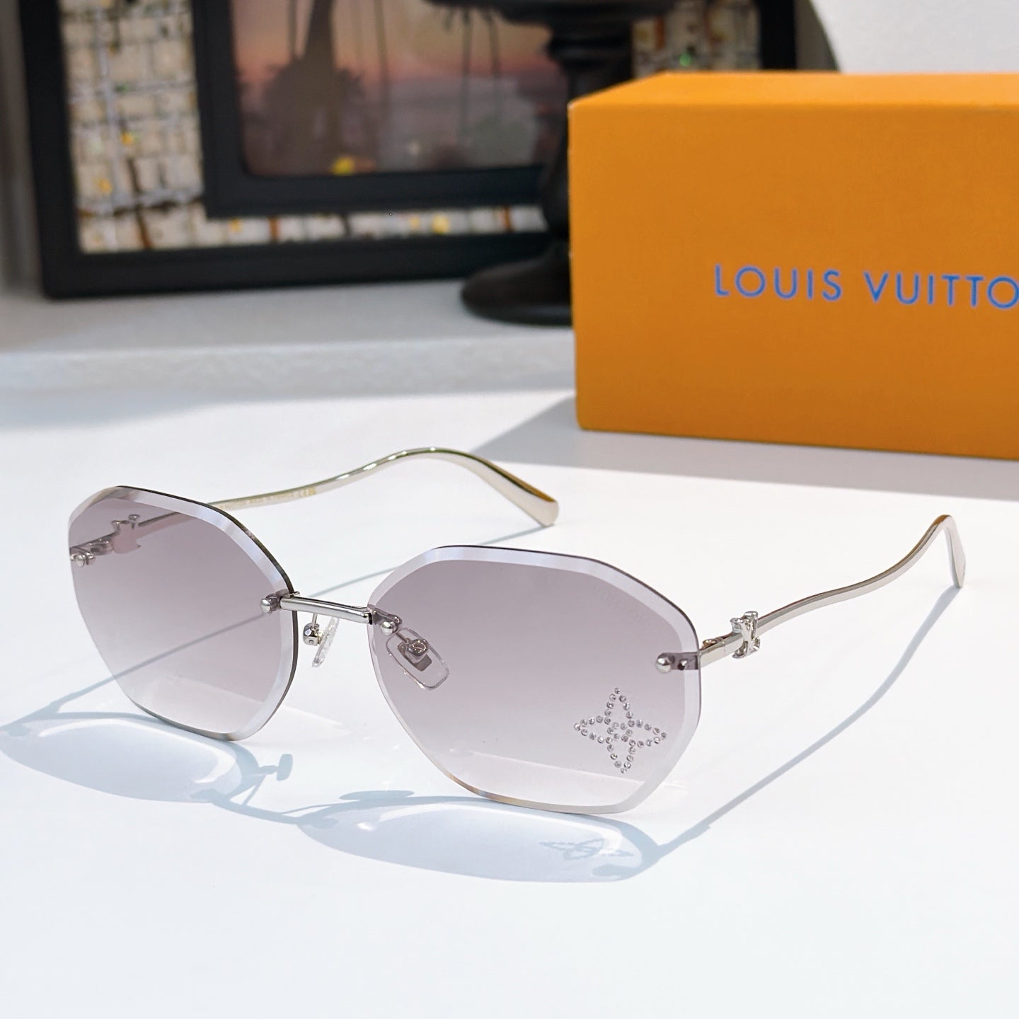 Louis Vuitton gold sunglasses with light purple lenses, cat-eye round shape