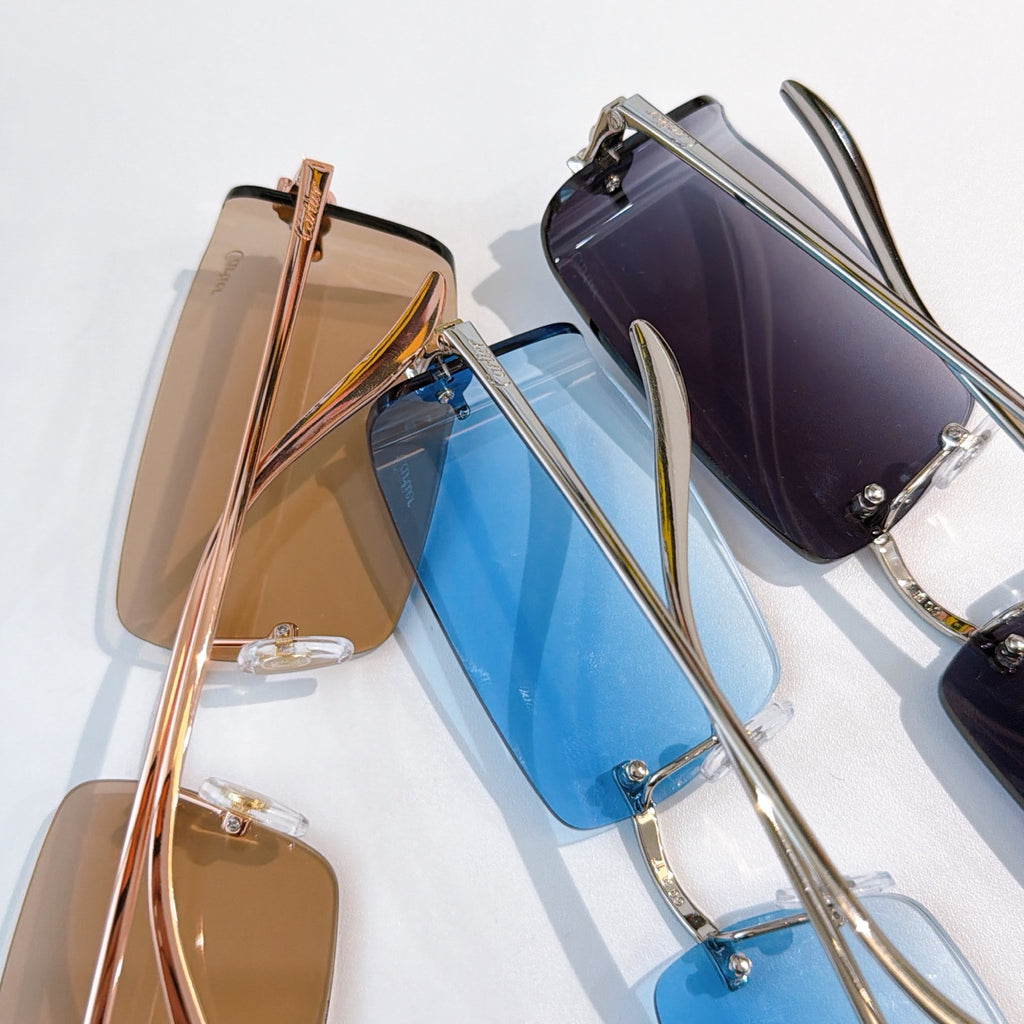 Cartier sunglasses stack with brown and blue tinted lenses, metal frames