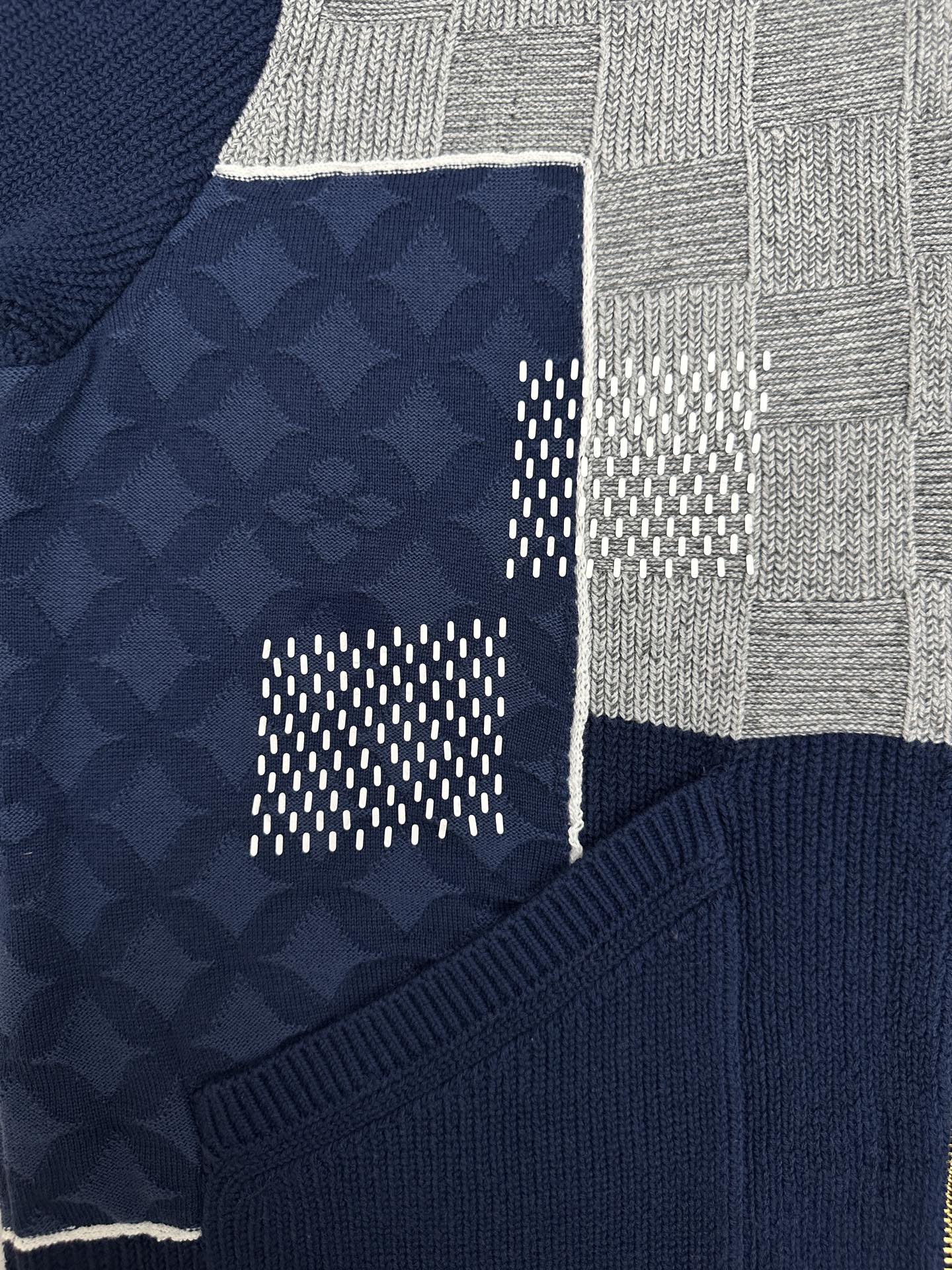 Patchwork detail of navy knit jacket with textured logo panel and gray checkered section