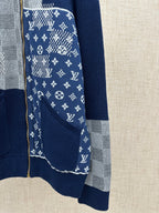 Lower sleeve detail on navy knit jacket with logo-pattern panel and gray checkered stripe
