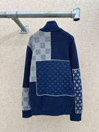 Navy knit sweater jacket with ribbed collar, checkered panels, and large square back patch