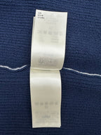 Dark blue knit garment with care and fabric information label on inside