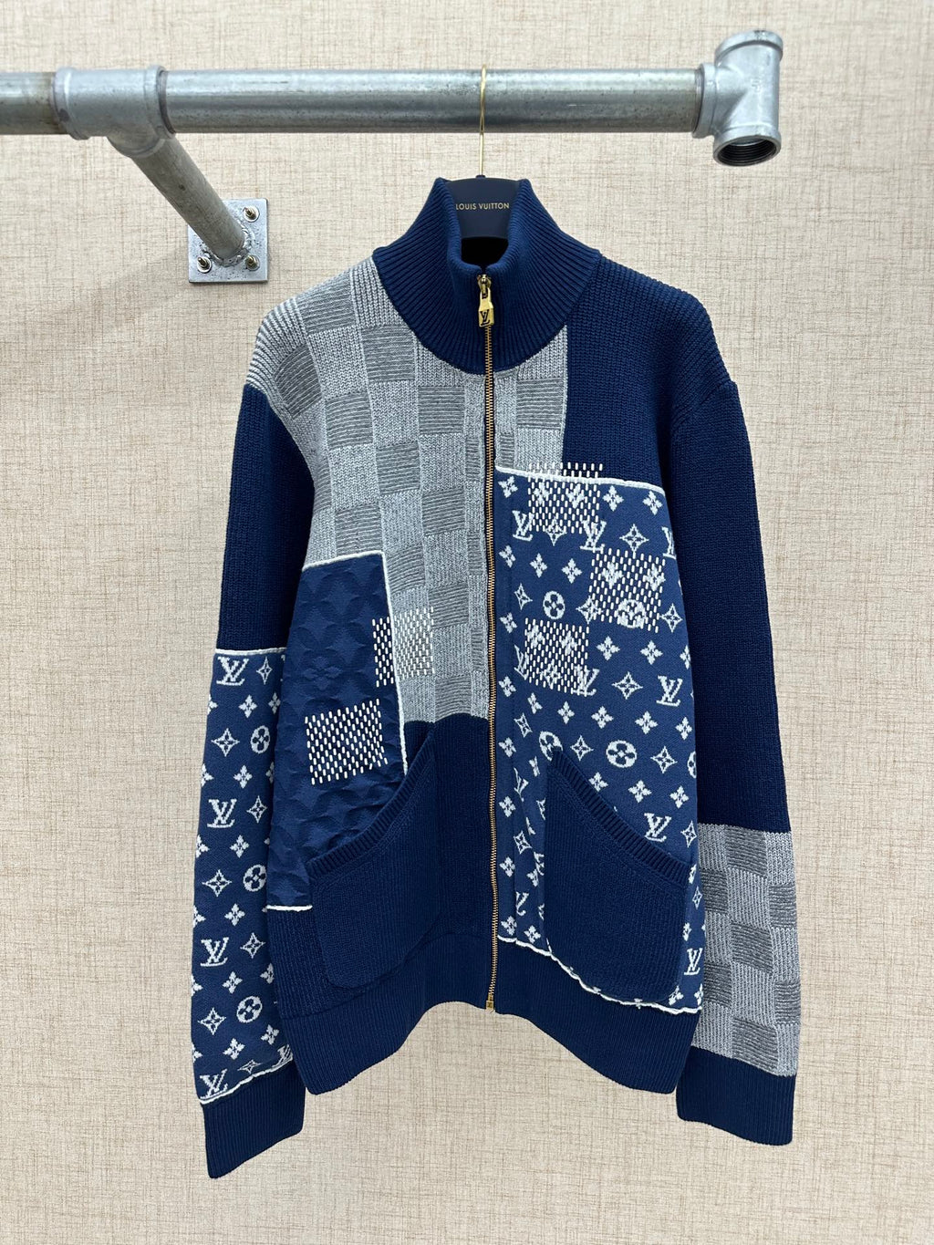 Long-sleeve knit jacket in navy and gray with patchwork panels and full zip front