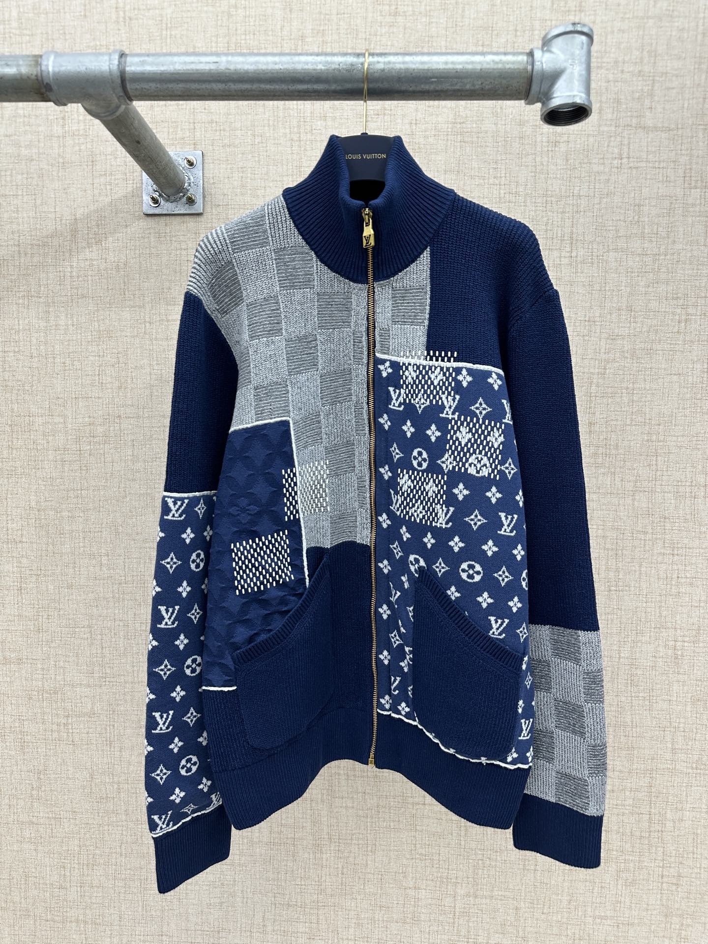 Long-sleeve knit jacket in navy and gray with patchwork panels and full zip front