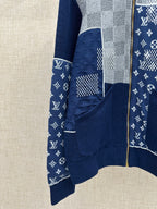Front view of navy knit jacket with dotted and monogram-style logo patch and zip closure