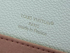Louis Vuitton embossing and “made in France” on cream leather with stitched trim
