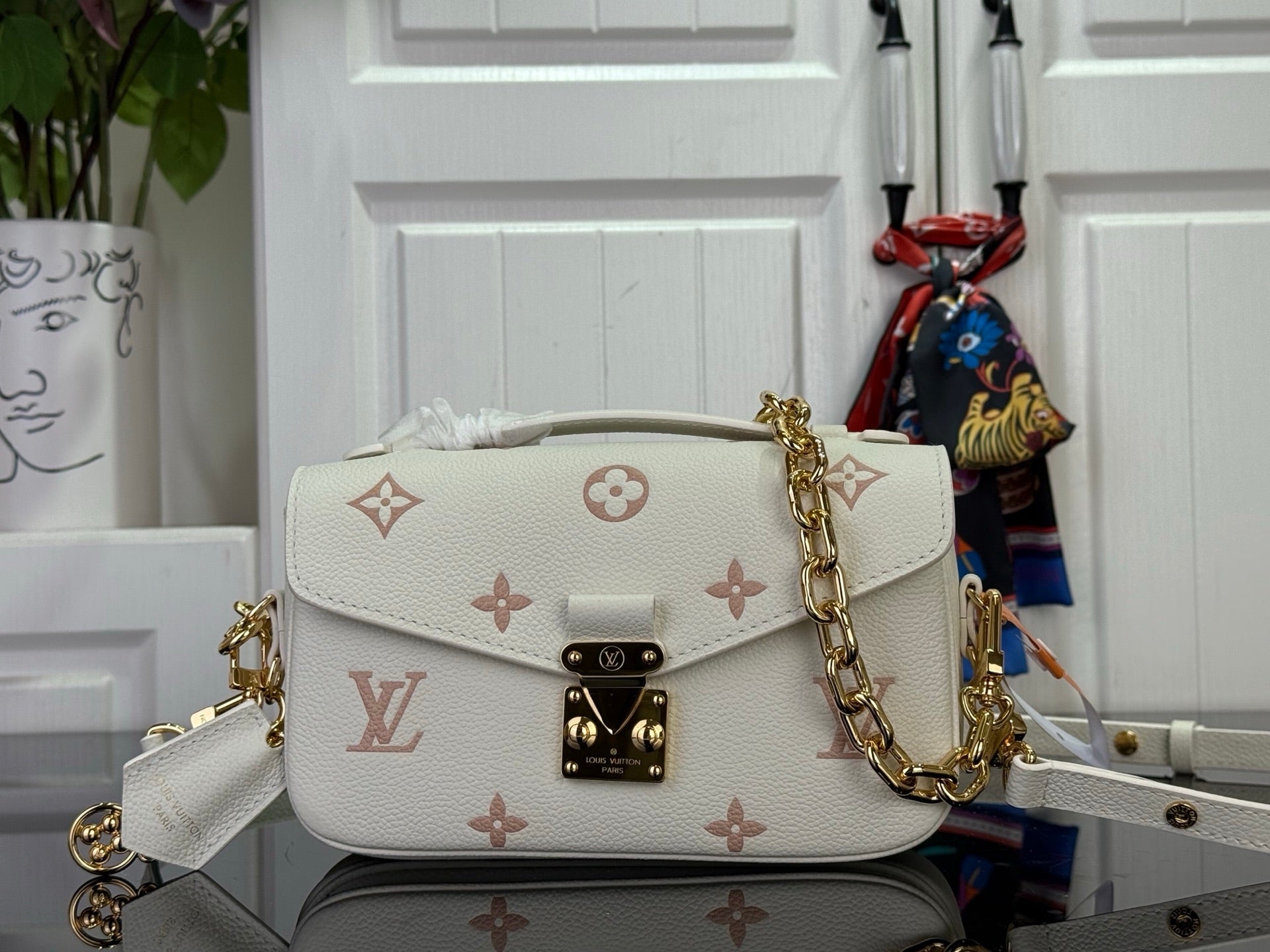 Louis Vuitton crossbody bag with flap, gold chain strap, light cream monogram pattern