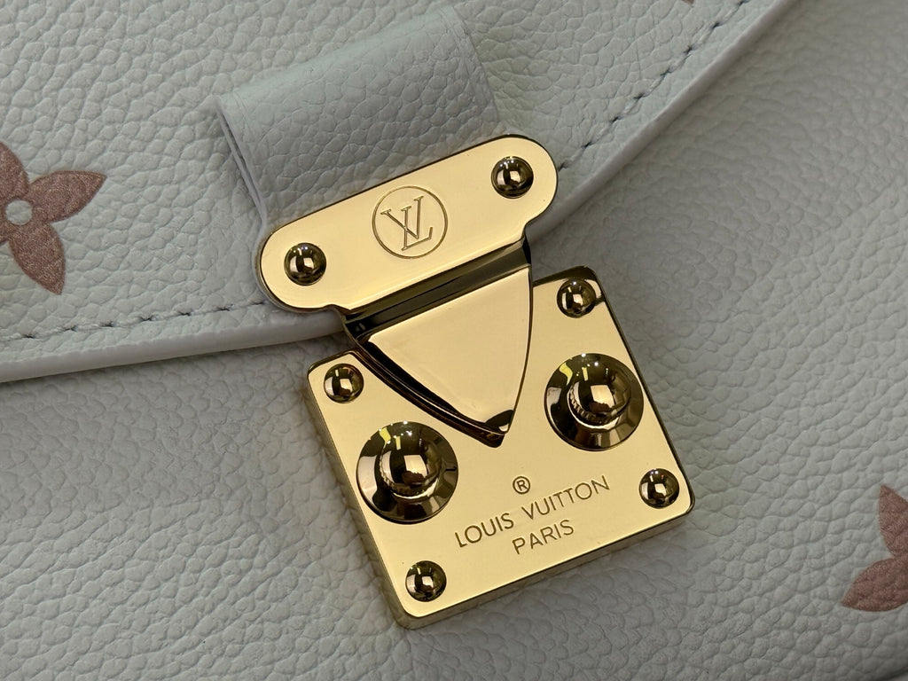Louis Vuitton logo gold-tone turn-lock on cream leather bag flap with studs
