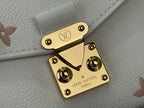 Louis Vuitton logo gold-tone turn-lock on cream leather bag flap with studs
