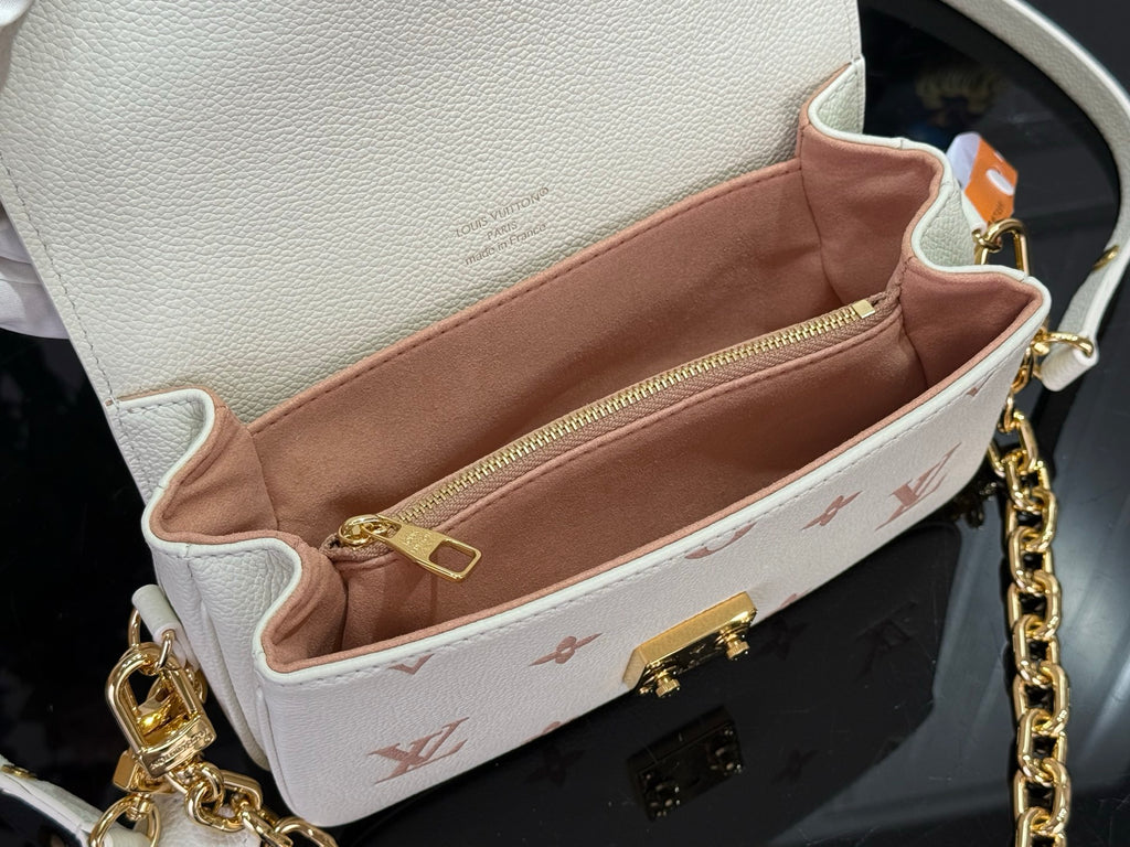 Louis Vuitton mini crossbody bag interior view, tan lining and gold zipper hardware