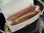 Louis Vuitton mini crossbody bag interior view, tan lining and gold zipper hardware