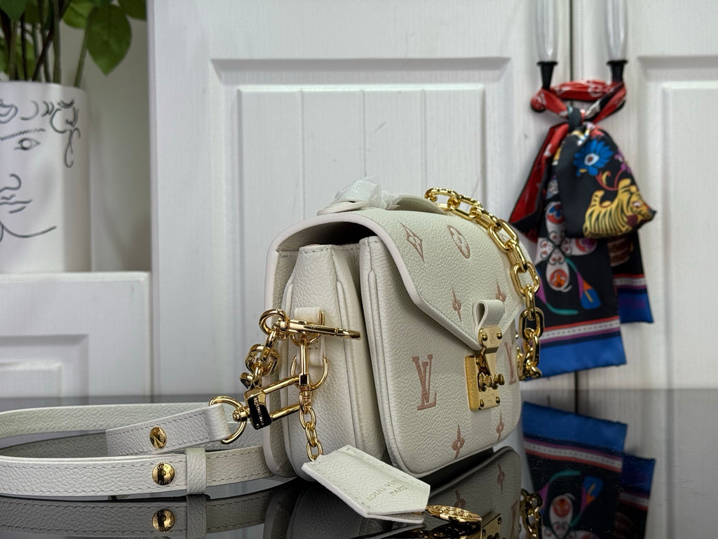 Louis Vuitton crossbody bag, side view with adjustable light gray strap and gold hardware
