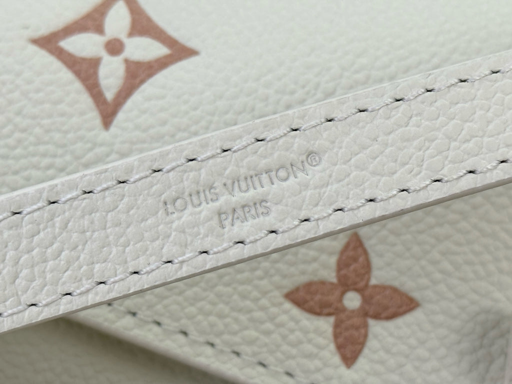 Louis Vuitton embossed logo on cream leather with cross-stitch trim and monogram marks