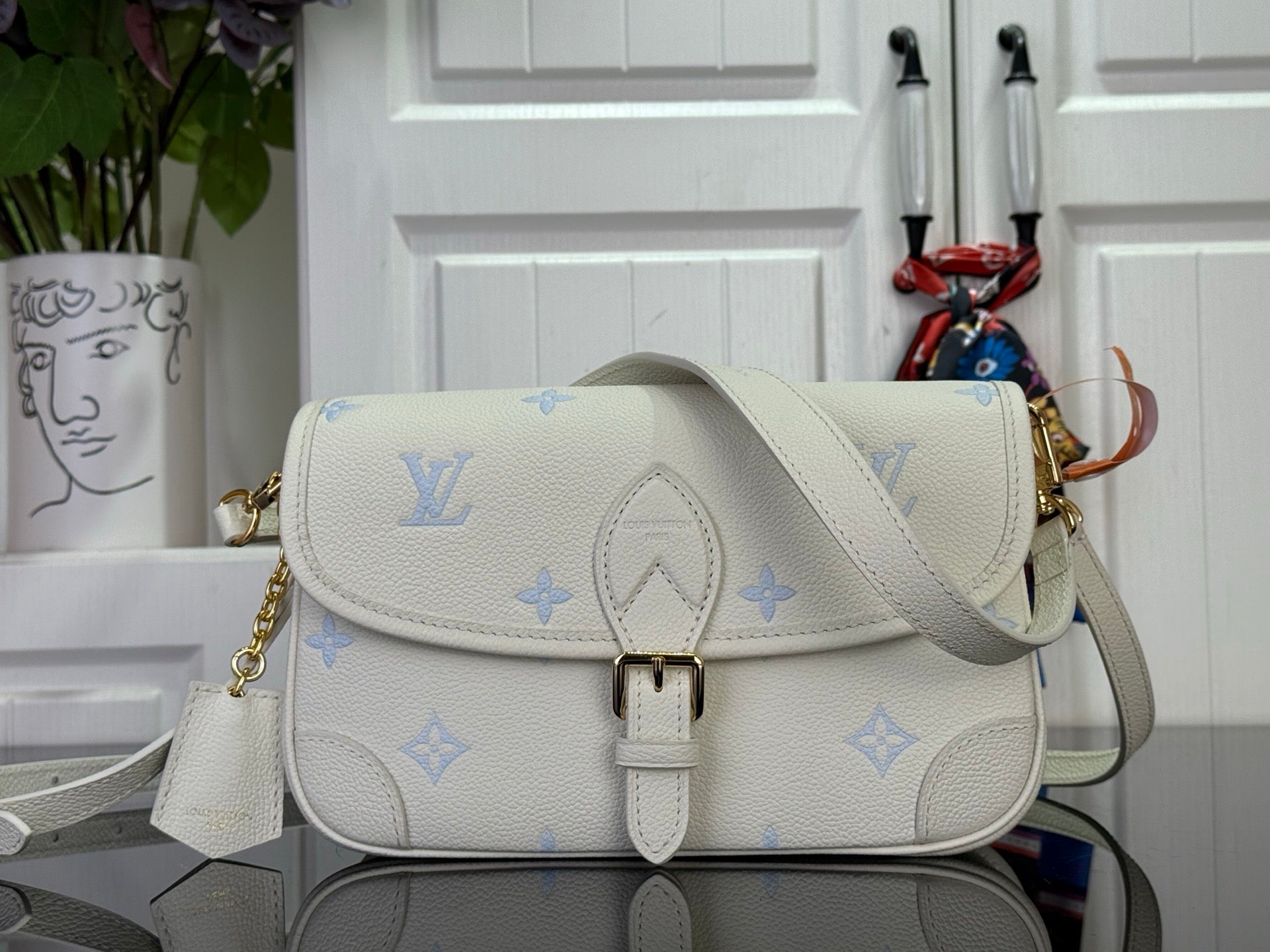 Louis Vuitton monogram shoulder bag with flap buckle and crossbody strap, cream/blue