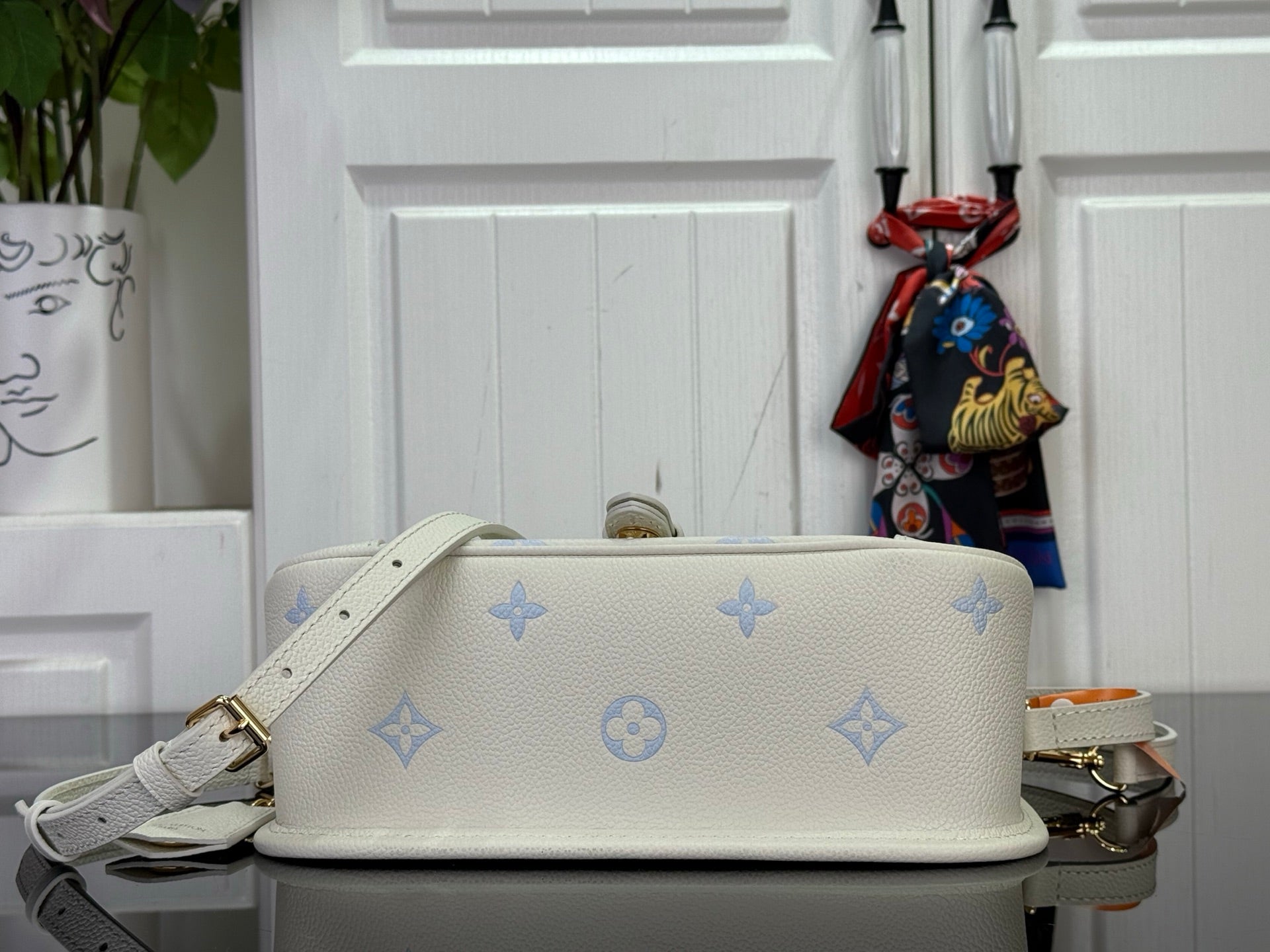 Louis Vuitton monogram crossbody bag with top flap and chain strap, cream/blue