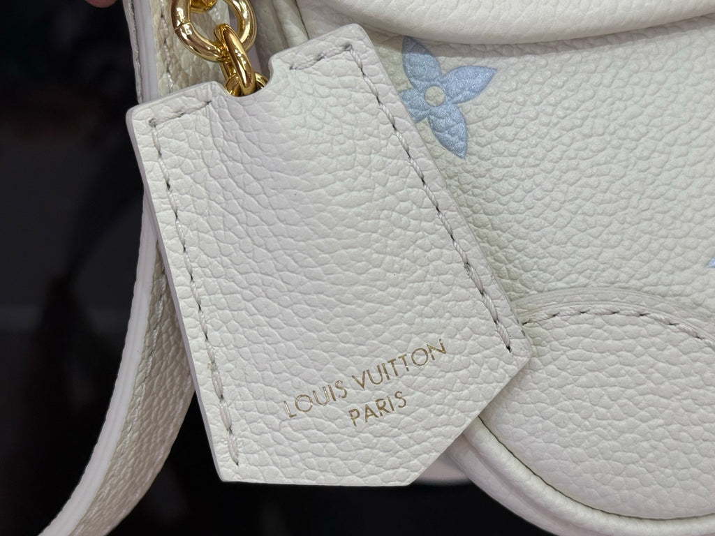 Louis Vuitton Paris embossed leather tag on white crossbody bag