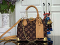Monogram handbag with tan leather trim, gold-tone hardware, top handles and crossbody strap