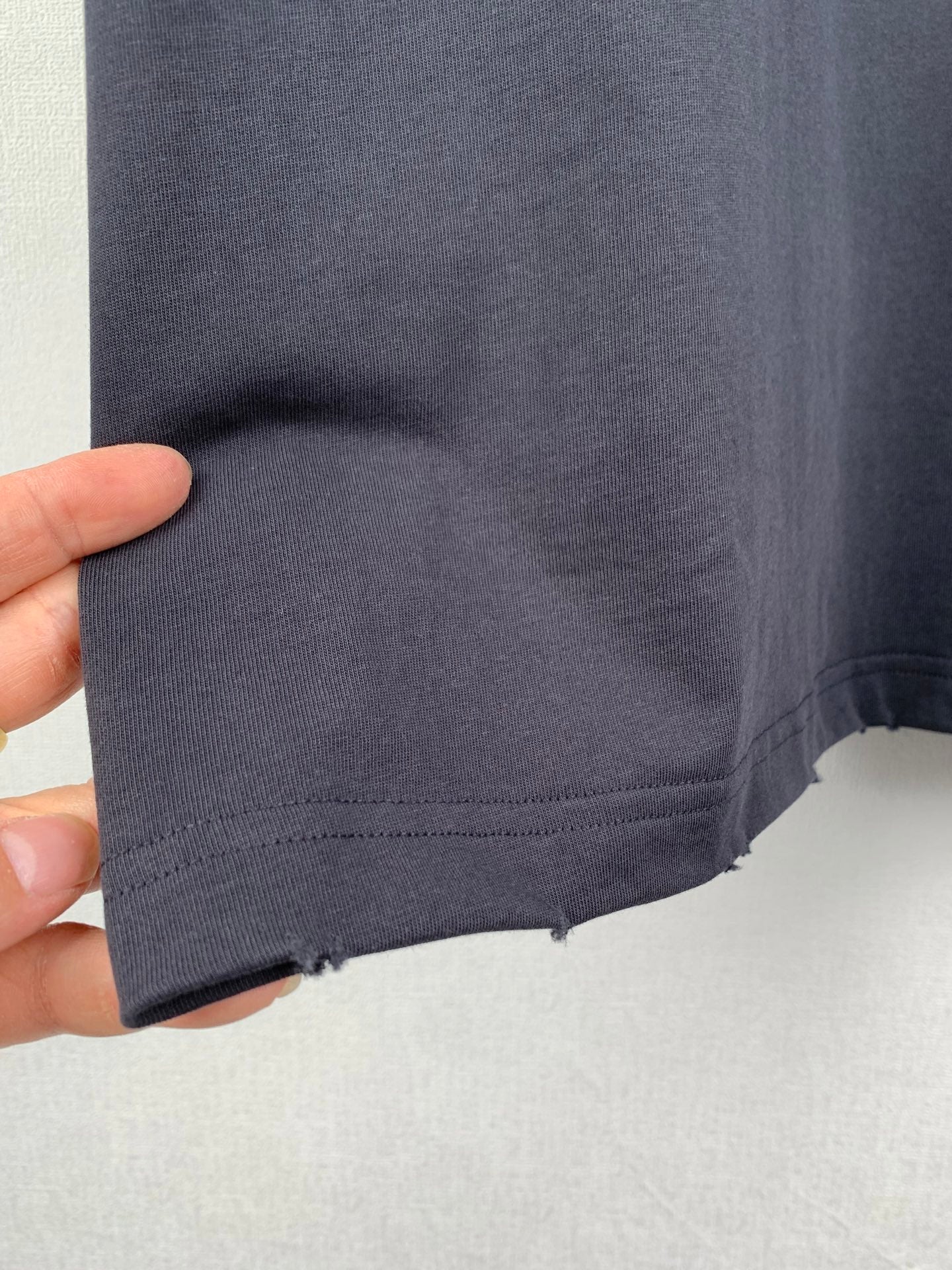 Balenciaga T-shirt bottom hem with stitched edge and slight wear