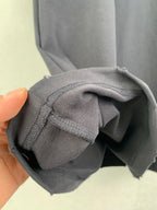Balenciaga T-shirt sleeve cuff and seam close-up with hand