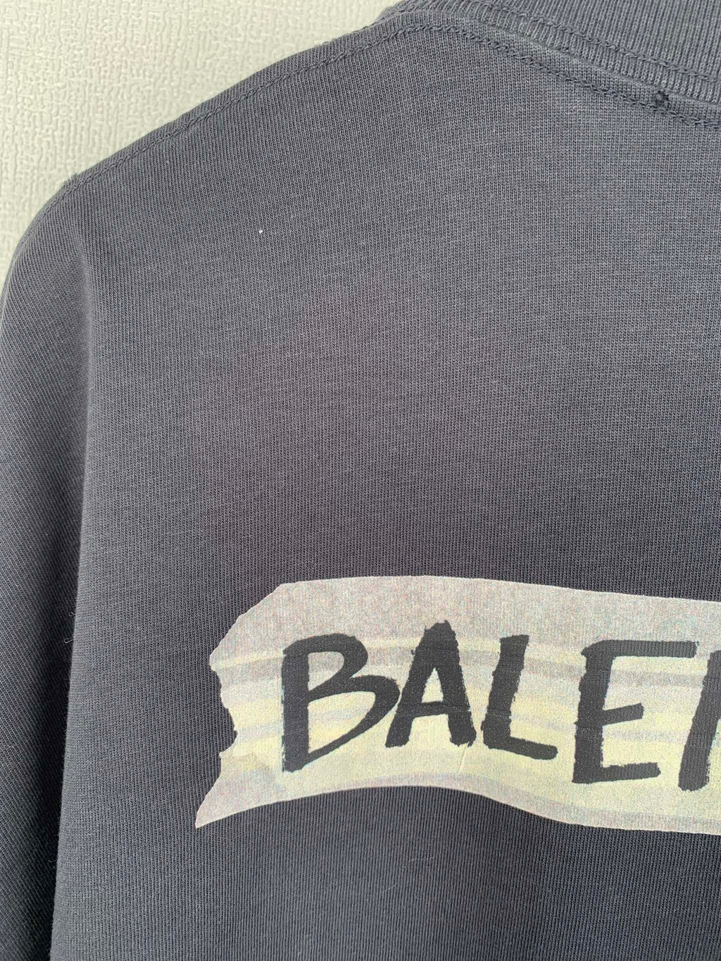 Dark short-sleeve top with BALENCIAGA logo print on chest