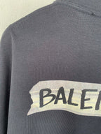 Dark short-sleeve top with BALENCIAGA logo print on chest