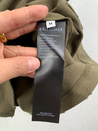 Olive green shorts with interior fabric tag and Balenciaga logo label