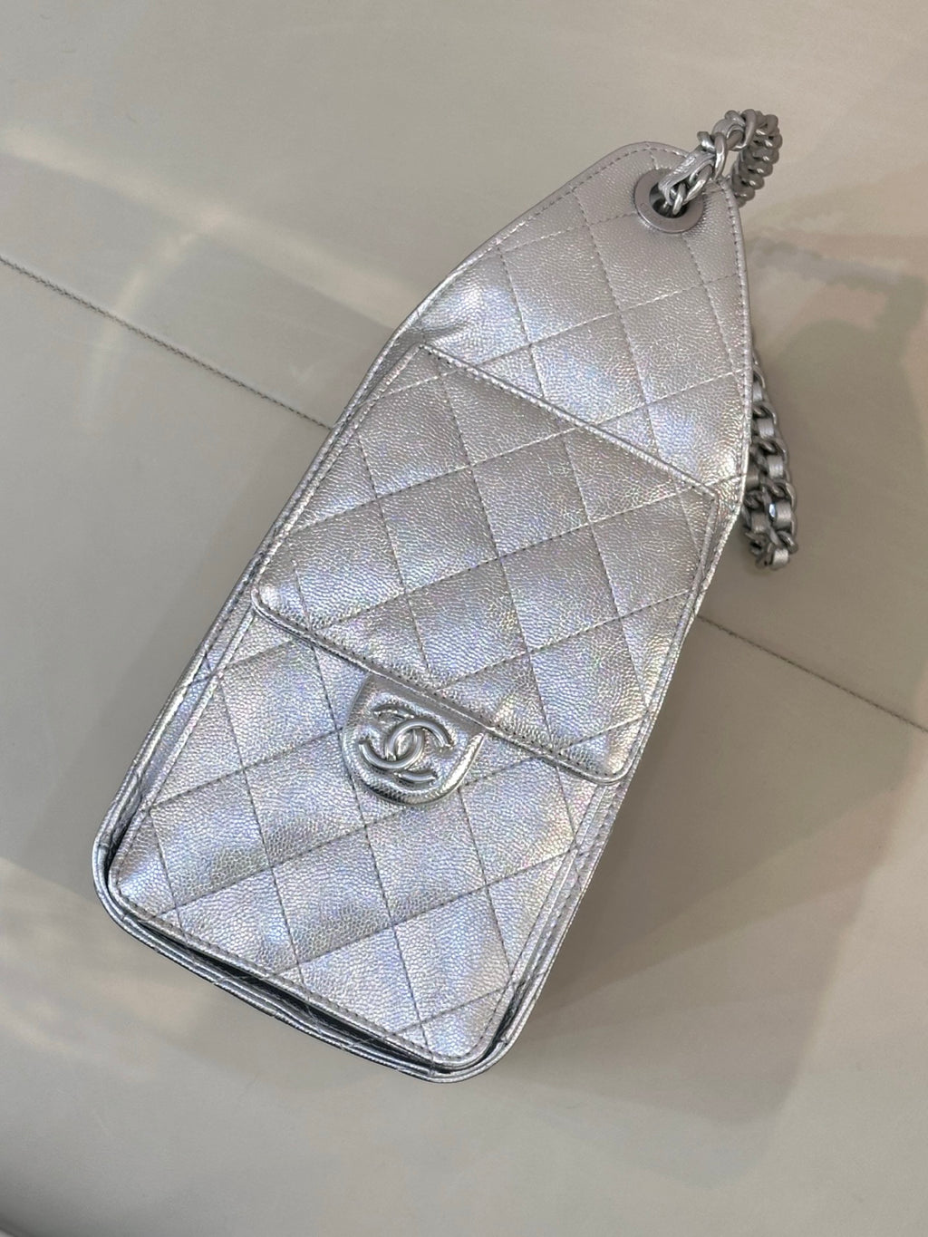 Chanel quilted chain crossbody bag in silver tone, flap-style front with logo charm