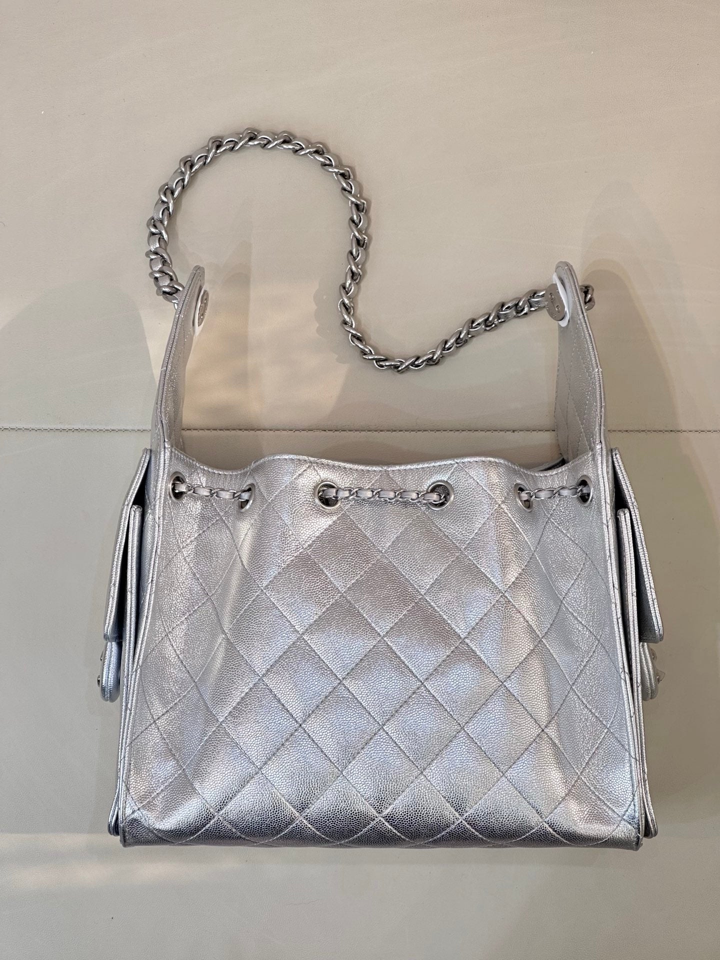 Chanel quilted chain-strap shoulder bag in silver tone, front view with drawcord closures