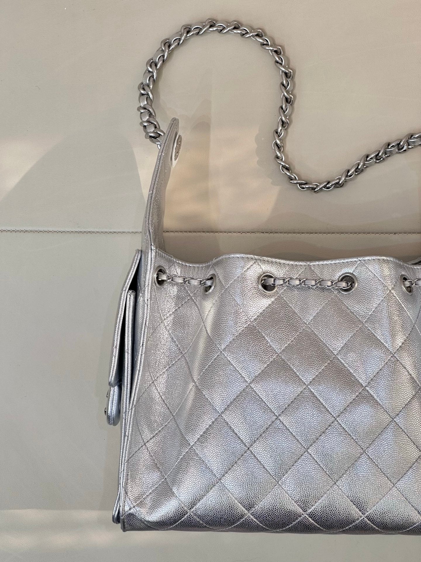 Chanel quilted chain-strap shoulder bag in silver tone, front pocket details and quilted pattern