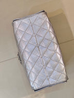 Chanel quilted chain-strap bucket-style bag in silver tone, side profile with tie closure