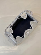 Chanel quilted chain-strap bag in silver tone, open top showing dark interior lining