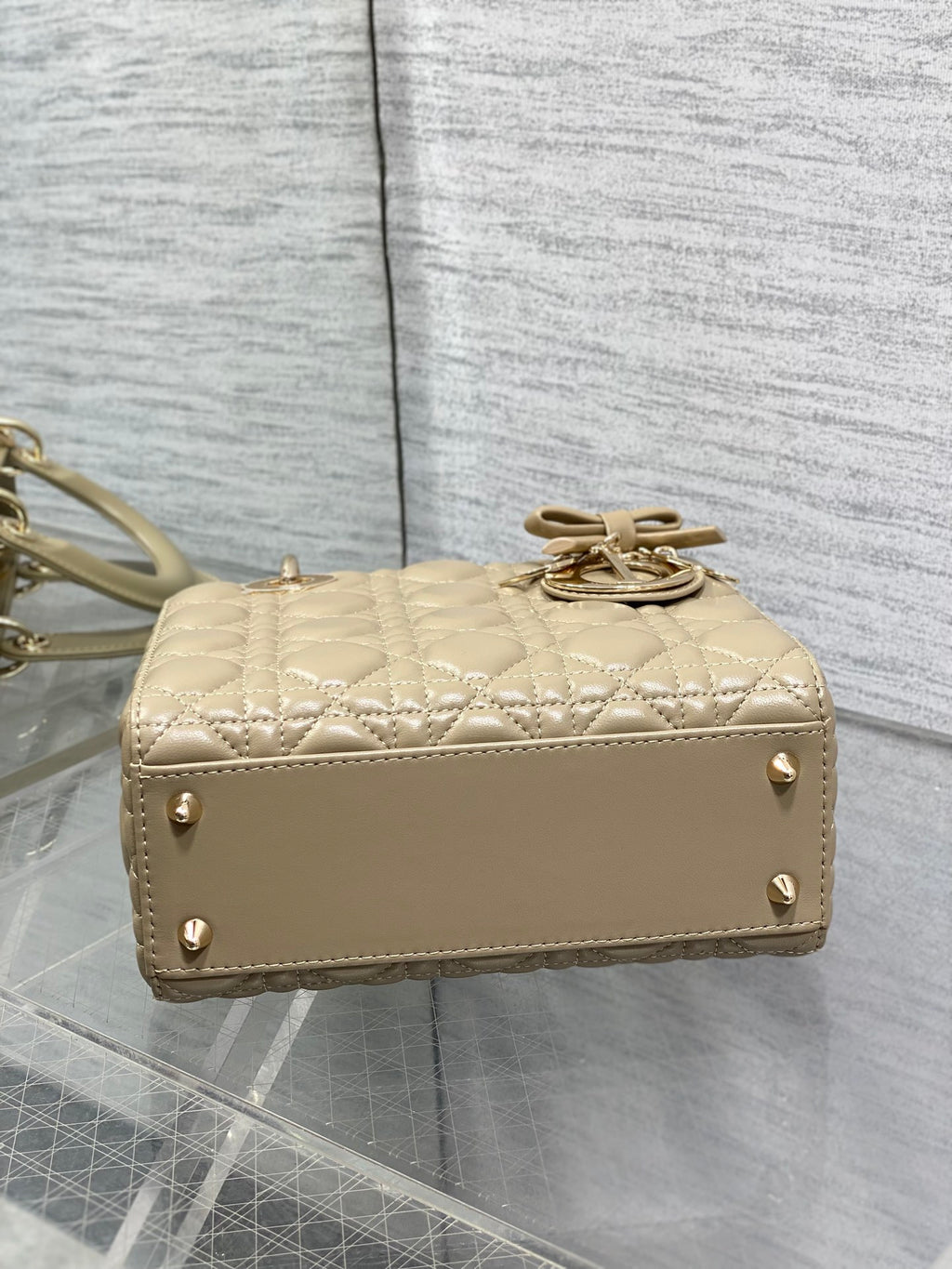 Dior quilted mini handbag with top clasp and short handle strap in beige